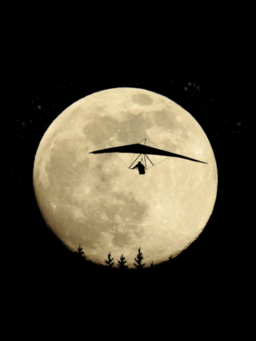 Hang gliding full moon at night flight with stars